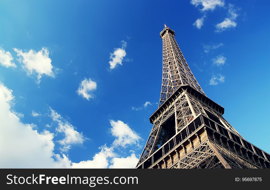 The famous landmark of Paris, Eiffel Tower against the blue sky. The famous landmark of Paris, Eiffel Tower against the blue sky.