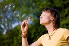 Young Woman And Soap-bubbles Stock Photography