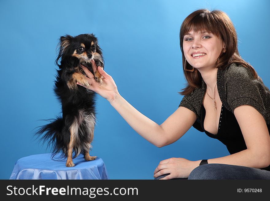 The girl with the doggie on a blue background