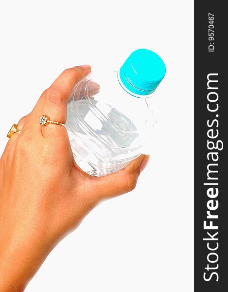 Female hand holding plastic bottle.