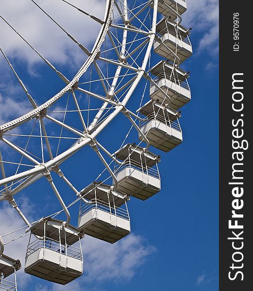 Ferris wheel against a deep blue sky