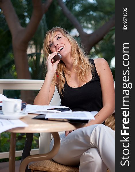 Young attractive businesswoman talking by phone. Young attractive businesswoman talking by phone