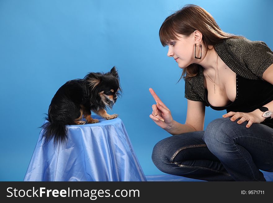 The girl with the doggie on a blue background