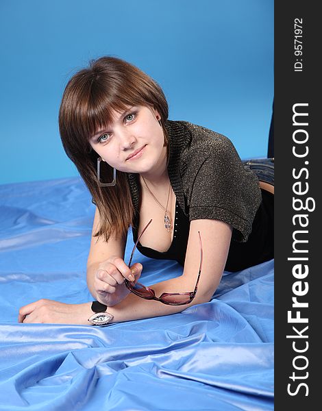The young girl on a blue background. The young girl on a blue background