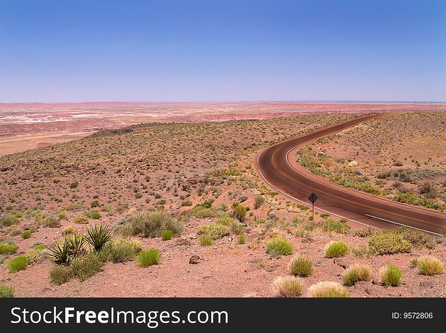 A lone highway runs through the Arizona desert. A lone highway runs through the Arizona desert.