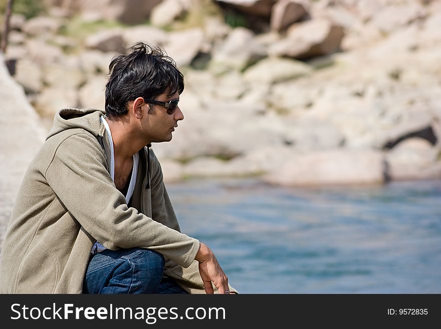 Happy young man enjoying and relaxing  on the river. Happy young man enjoying and relaxing  on the river