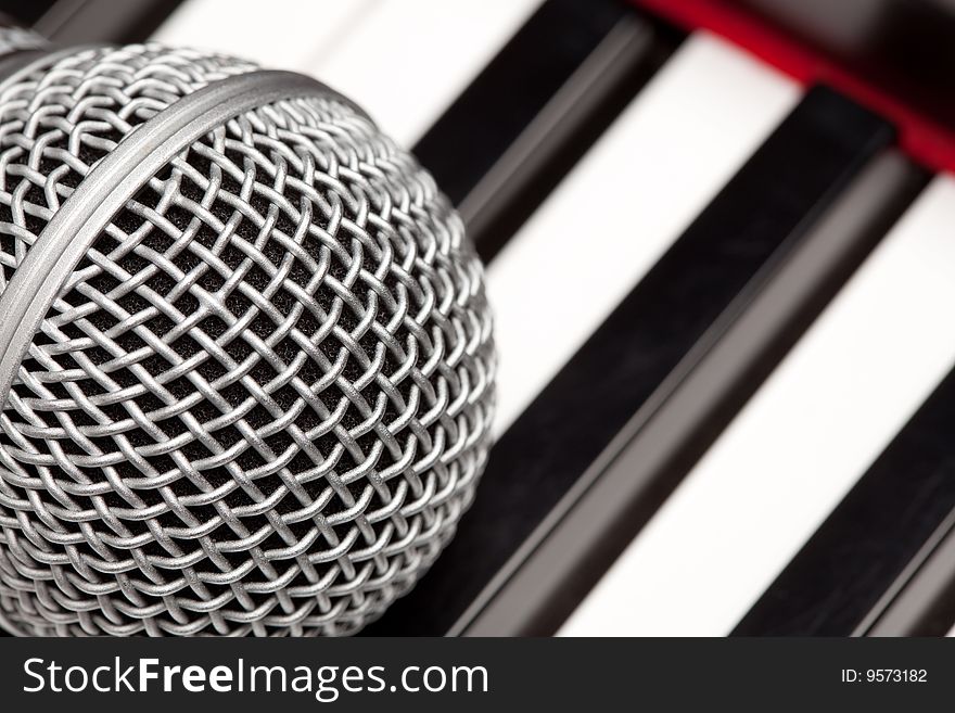 Microphone Laying on Electronic Keyboard with Narrow Depth of Field.