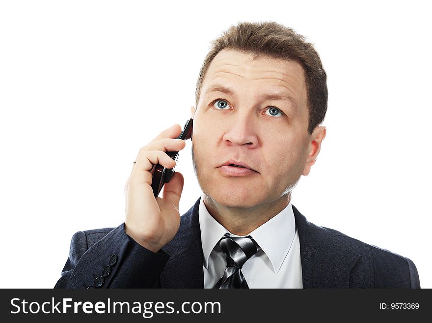 Portrait of a middle aged businessman talking on his mobile phone. Shot in a studio. Portrait of a middle aged businessman talking on his mobile phone. Shot in a studio.