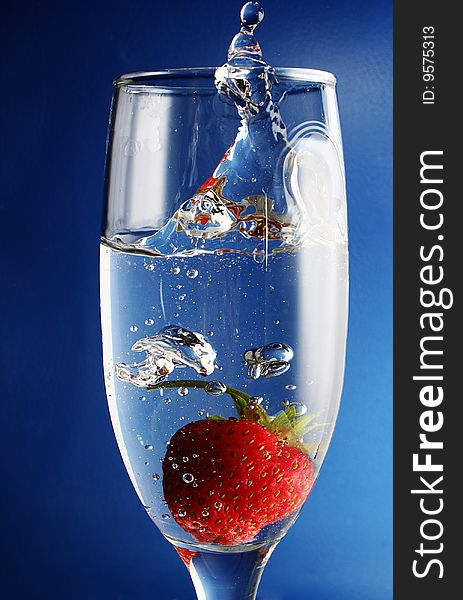 Strawberries falls in goblet with water. Strawberries falls in goblet with water
