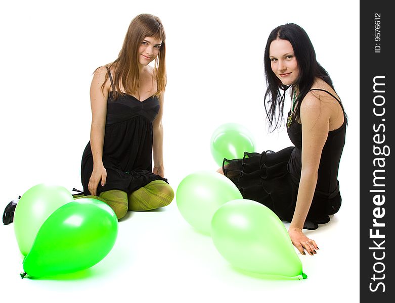 Two young girls with green balloons. Isolated on white background. Two young girls with green balloons. Isolated on white background