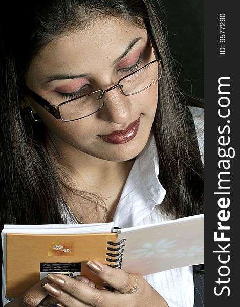 Girl reading the notebook in studio.