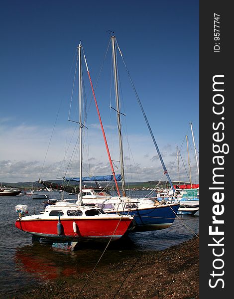 Moored yachts at low tide