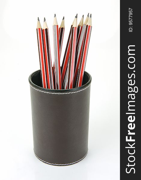 Lead pencils in a cup holder isolated against a white background. Lead pencils in a cup holder isolated against a white background