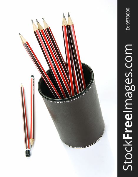 Lead pencils in a cup holder isolated against a white background. Lead pencils in a cup holder isolated against a white background