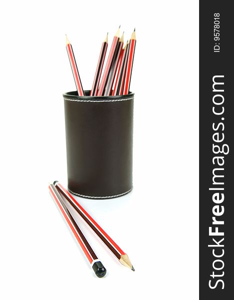 Lead pencils in a cup holder isolated against a white background. Lead pencils in a cup holder isolated against a white background