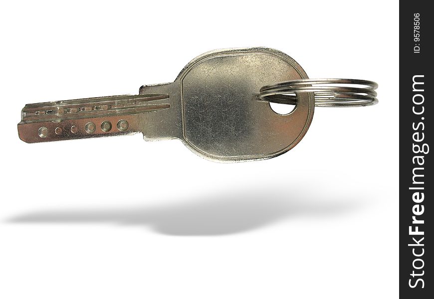 Metallic key with ring and shadow isolated over white background