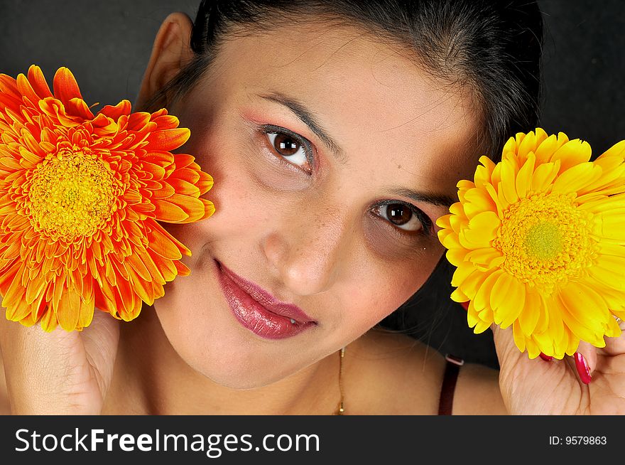 Girl with flower posing in studio.