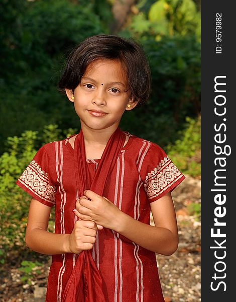 A smart Indian girl with traditional dress and happy mood. A smart Indian girl with traditional dress and happy mood.