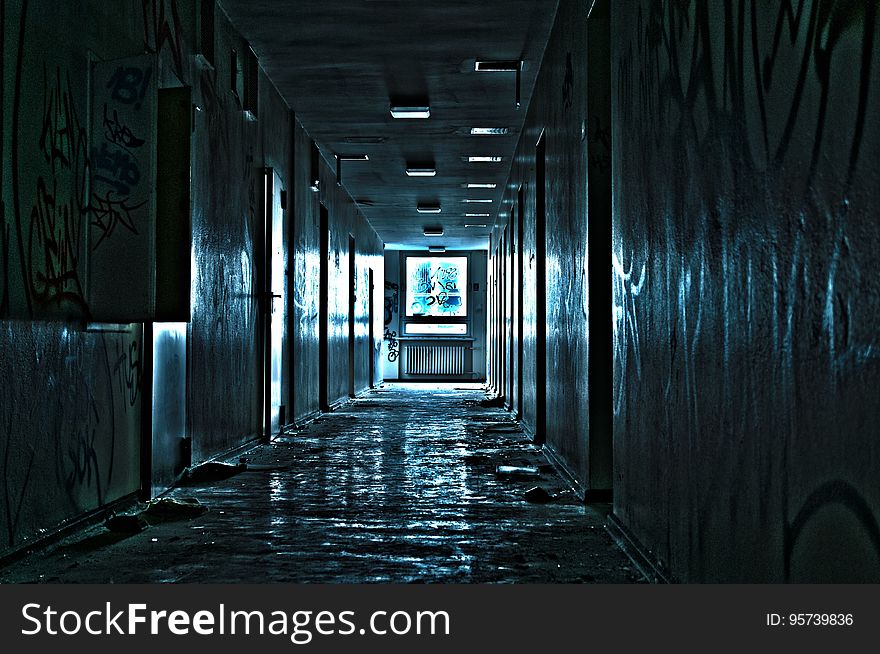 Hallway illuminated with blue lights inside abandoned building. Hallway illuminated with blue lights inside abandoned building.