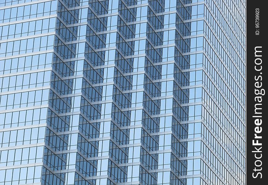 A contemporary skyscraper made of glass. A contemporary skyscraper made of glass.