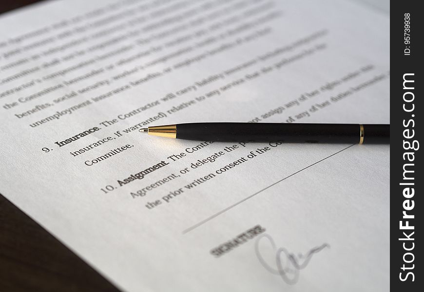 An agreement signed with a pen on top. An agreement signed with a pen on top.