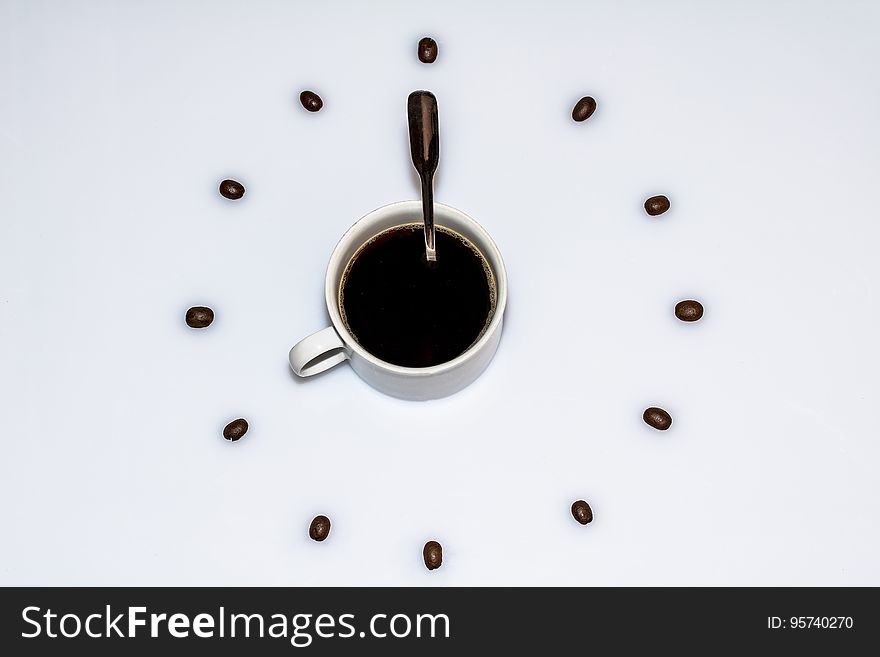 Cup Of Coffee Surrounded By Beans