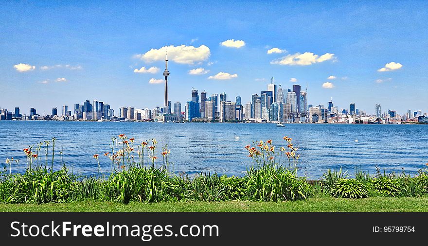 Skyline panorama of Toronto, Canada over blue waterfront on sunny day. Skyline panorama of Toronto, Canada over blue waterfront on sunny day.