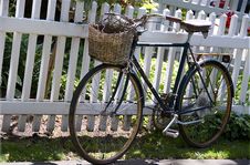 Old Rusty Bike Leaned To The White Fence Royalty Free Stock Image