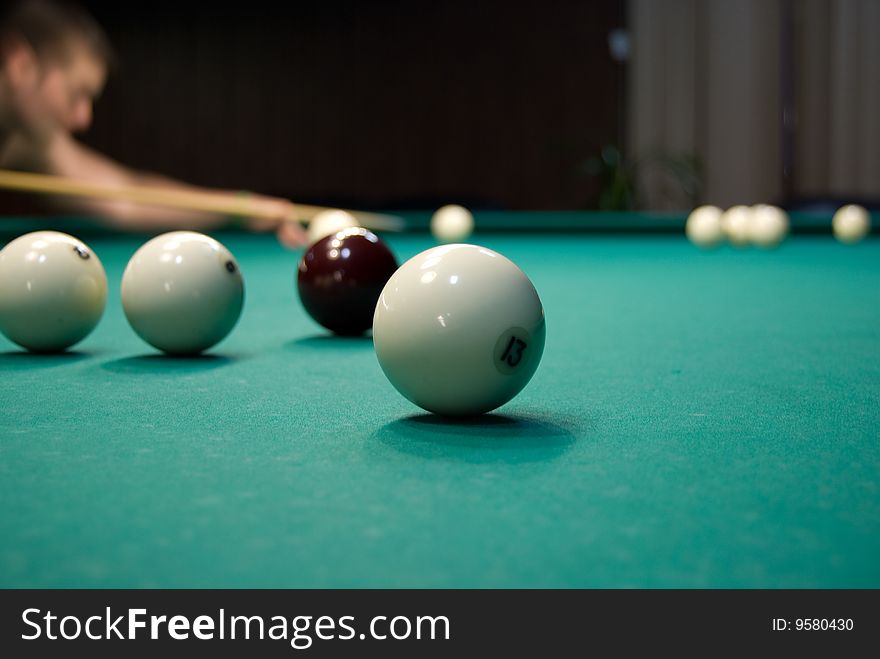 Billiards table ana a player making shot. Billiards table ana a player making shot