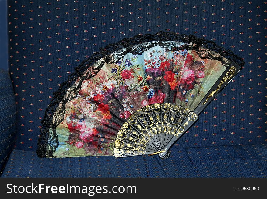 Colourful floral design on fabric hand fan. Colourful floral design on fabric hand fan