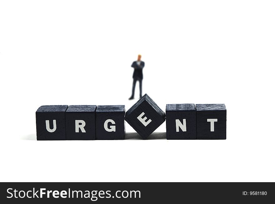 A businessman standing behind the word urgent. A businessman standing behind the word urgent