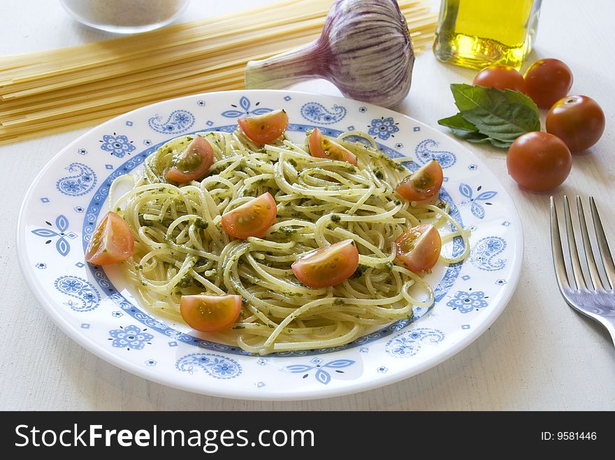 Spaghetti with pesto sauce and cherry tomatoes