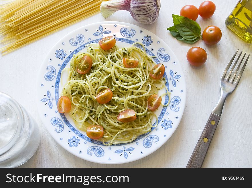 Spaghetti with pesto sauce and cherry tomatoes