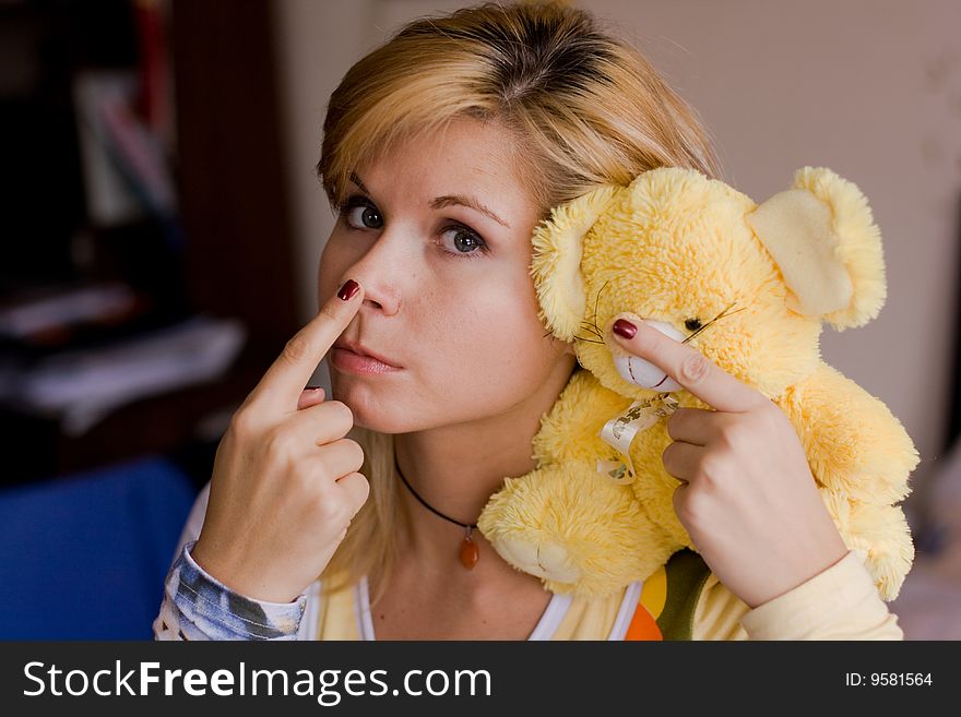 A girl holds a yellow toy-bear. A girl holds a yellow toy-bear