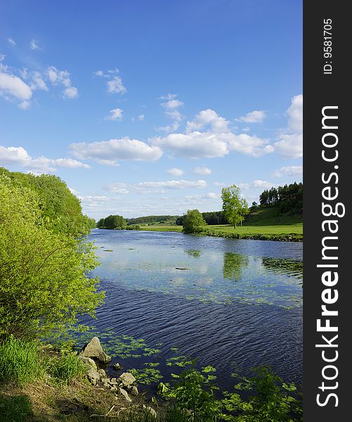 Landscape - meadow, the blue sky and river