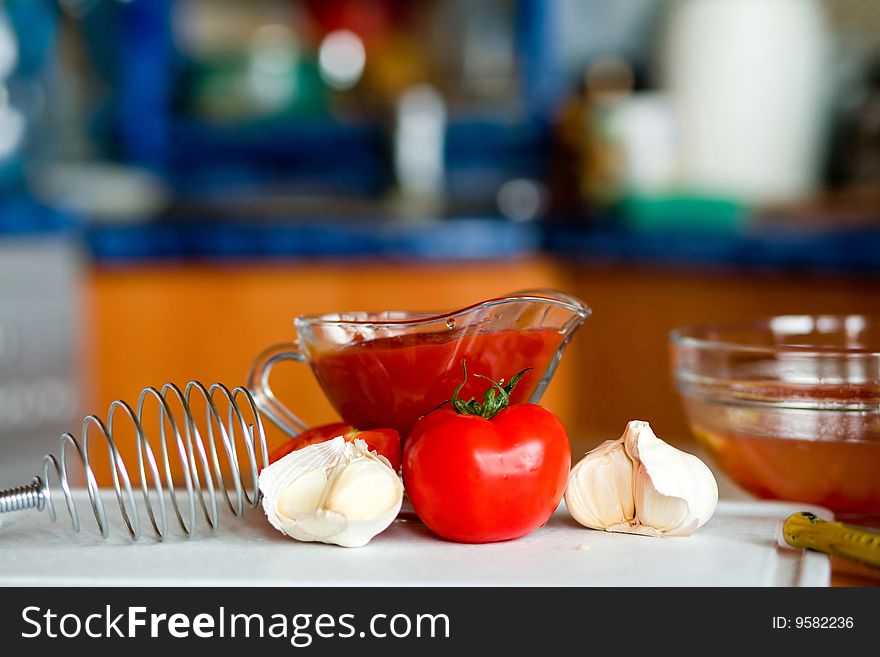 Appetizing tomatoes and garlic while preparing a poignant sauce. Appetizing tomatoes and garlic while preparing a poignant sauce