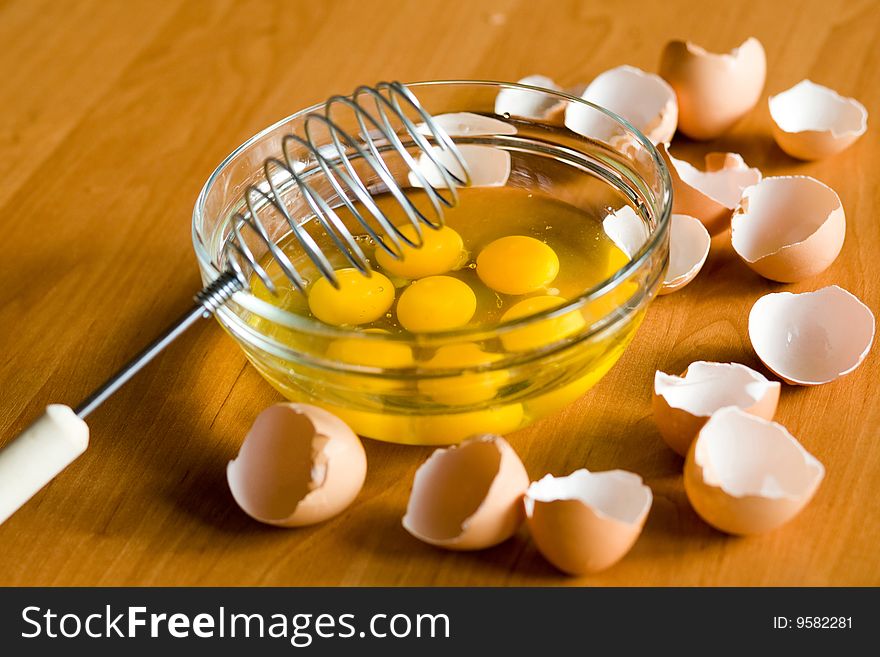 A glass plateful of eggs while an omelette preparing