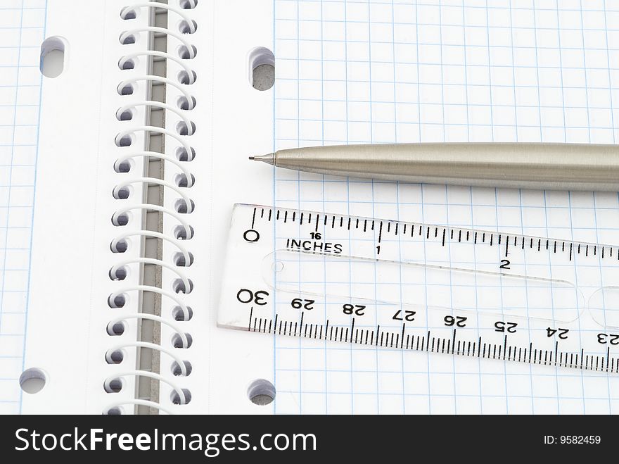 Business background with spiral notebook, pencil and ruler