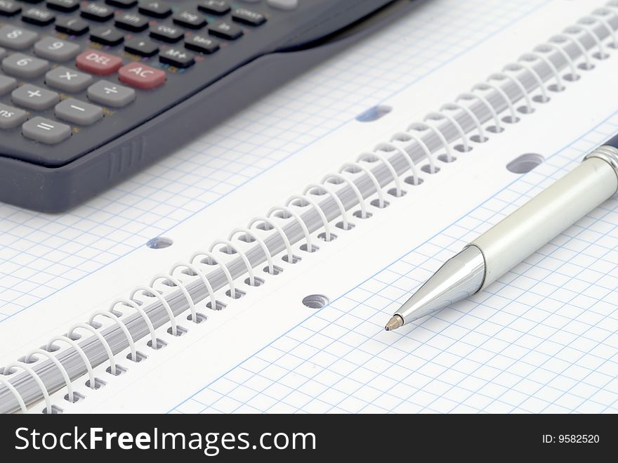 Business background. Spiral notebook with blue grid. Selective focus. Business background. Spiral notebook with blue grid. Selective focus