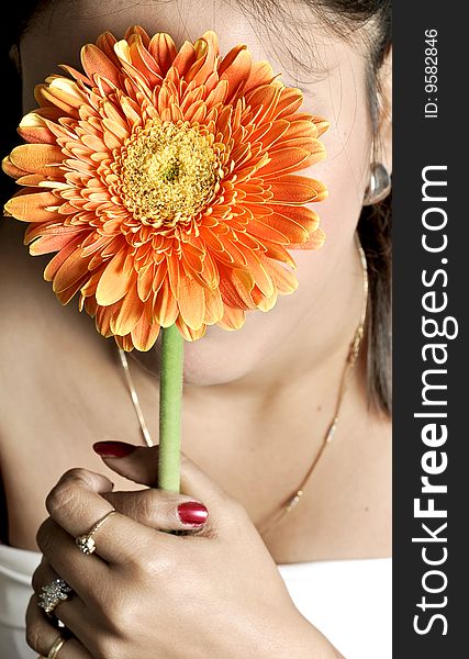 Girl holding holding flower in studio.