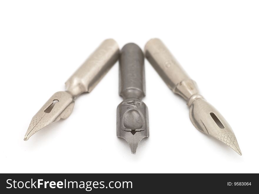 Old silver and steel fountain pens. Selective focus