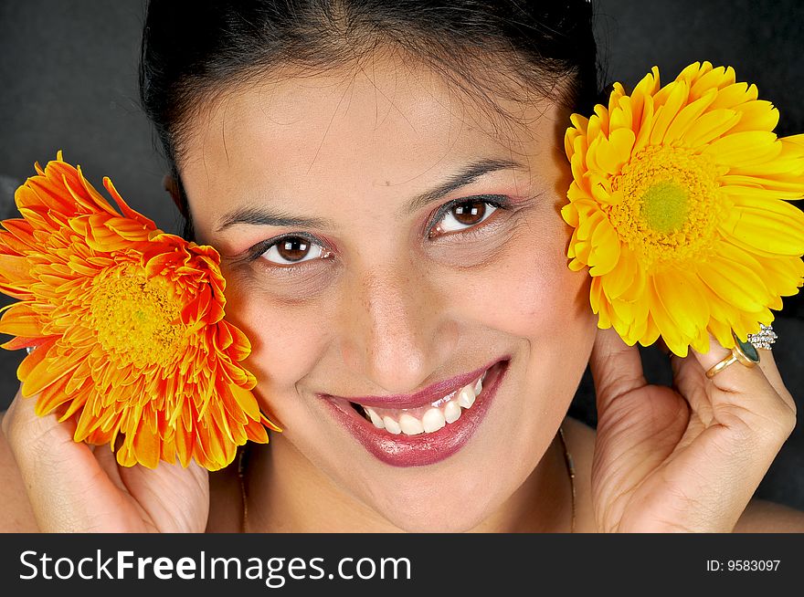 Girl with flowers posing in studio.