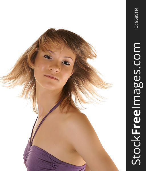 The girl with fluttering hair, is photographed on a white background