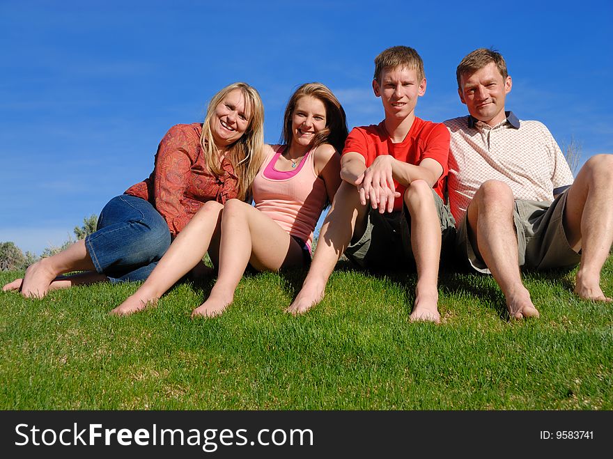 Colorado family posing on grass area. Colorado family posing on grass area