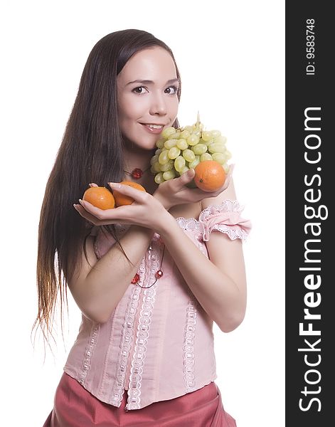 Brunette girl with fruit tangerines and grapes