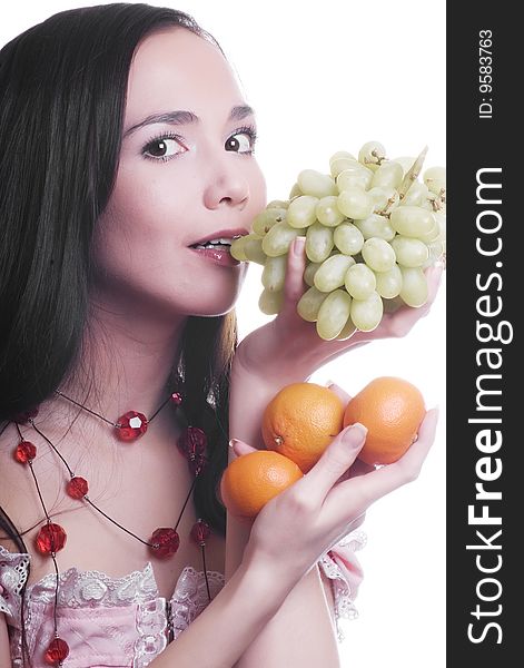 Brunette girl with fruit tangerines and grapes