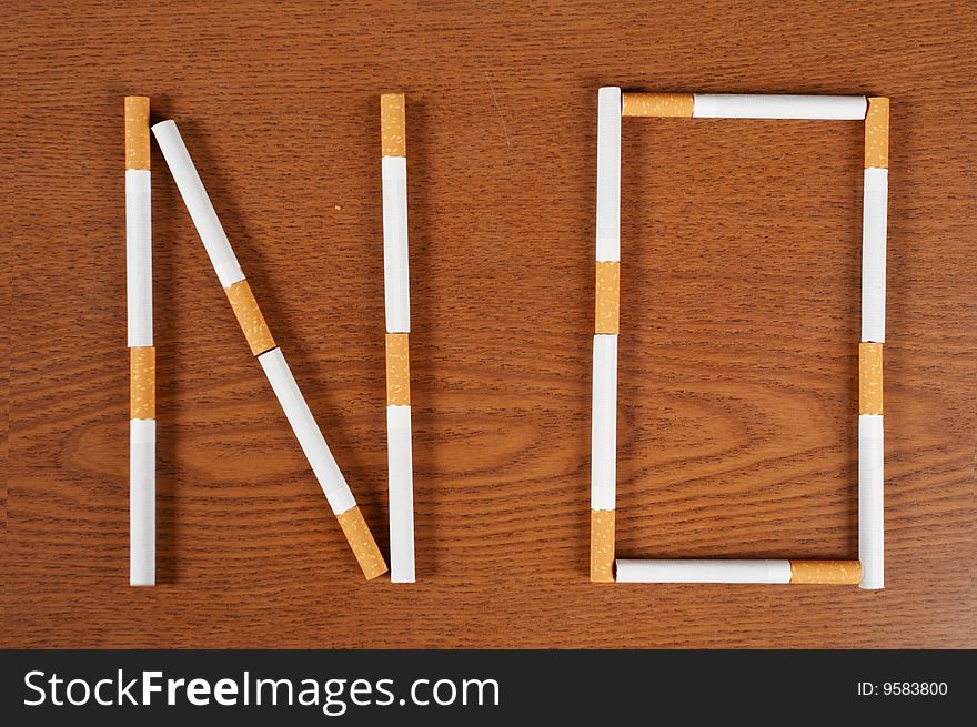 Cigarette  with brown wood background