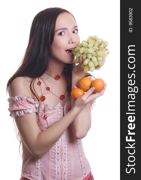 Brunette Beautiful smile with fruit tangerines and grapes