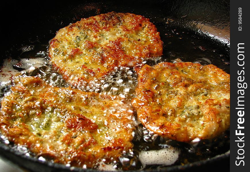 Cooking viennese schnitzel in a pan.