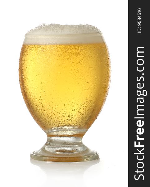 Glass of cold and fresh golden beer, over white background